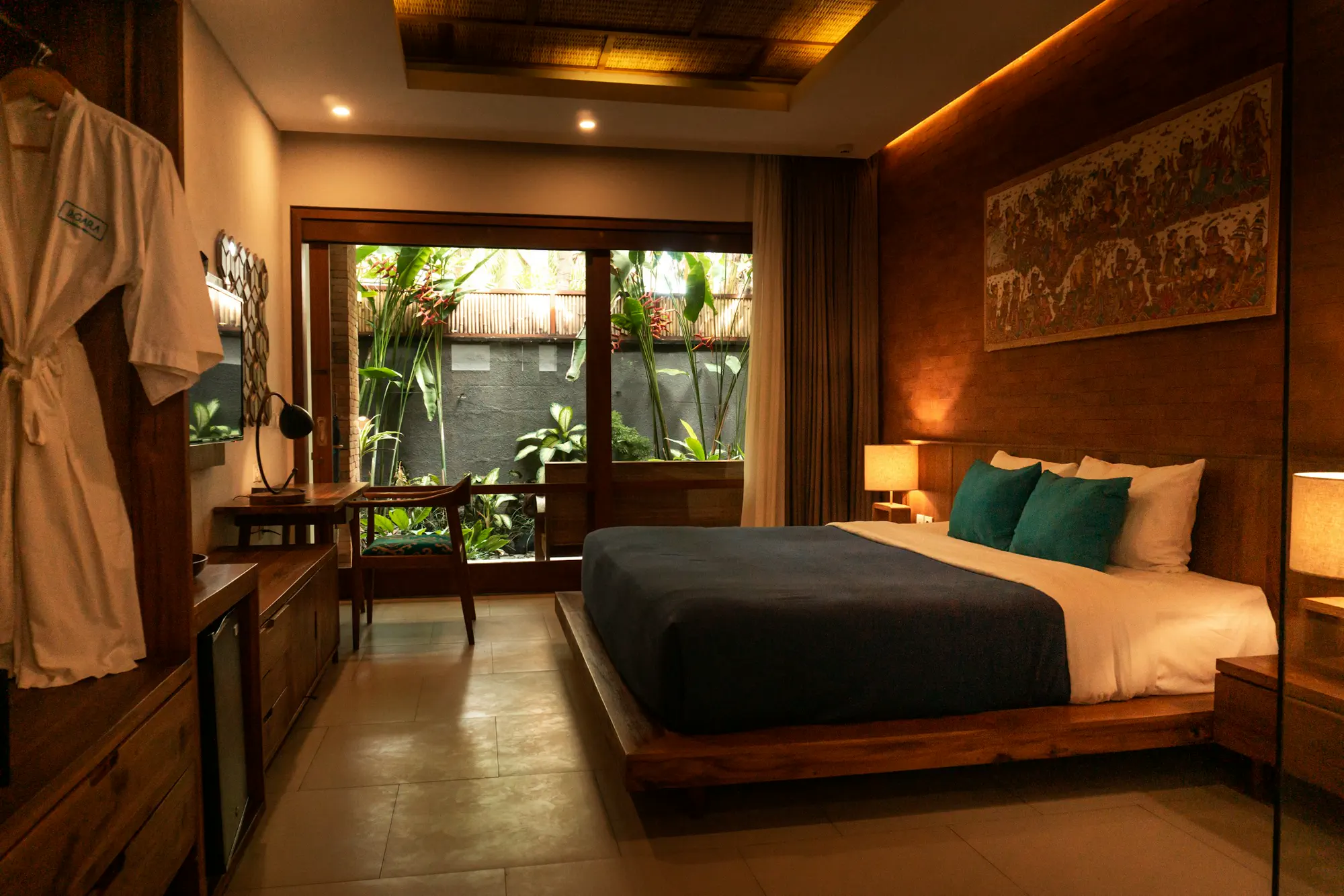 Sunlit luxury hotel suite with a made bed and warm brass-toned light — editorial still