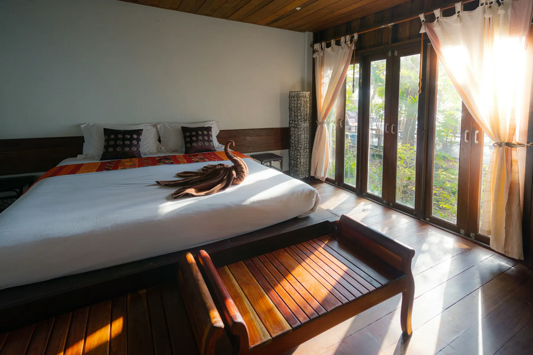Unsplash (sunlit suite) Empty hotel suite left guest-ready after turn-down — editorial still